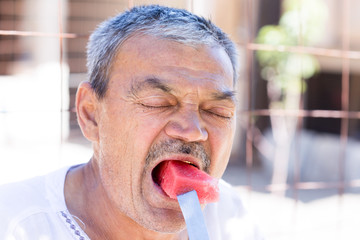 man eating a watermelon with gusto