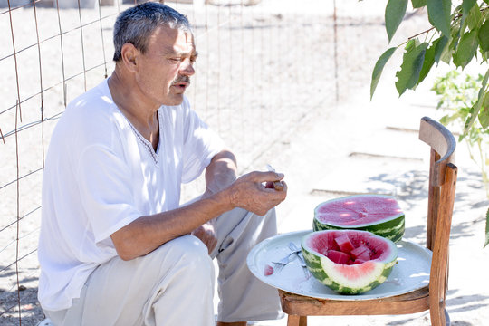 Man Eating A Watermelon With Gusto