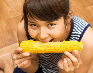 Girl eats corn