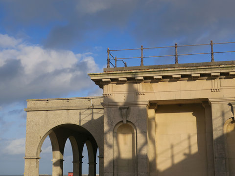 shadow of a statue of a man on a horse on the wall of a building