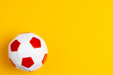 Red and white leather soccer ball, top view