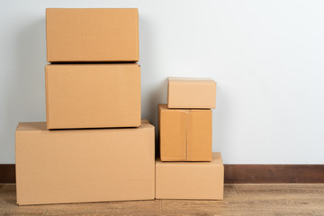 Group of brown carton boxes on wooden floor