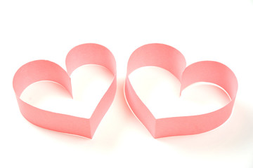 Couple of pink paper hearts on white background isolated