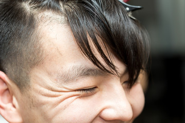 Fototapeta premium hairdresser cutting customer's hair