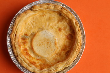 Delicious three cheese quiche in colored background