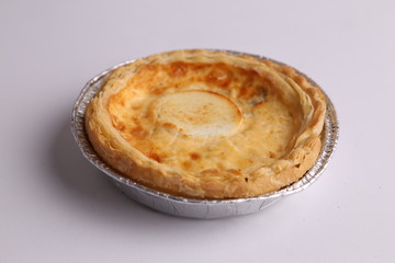 Delicious three cheese quiche in colored background