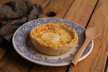 Delicious three cheese quiche in colored background