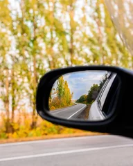 autumn landscape is reflected in the car mirror . cities that go into the distance © Taranova_ksenya