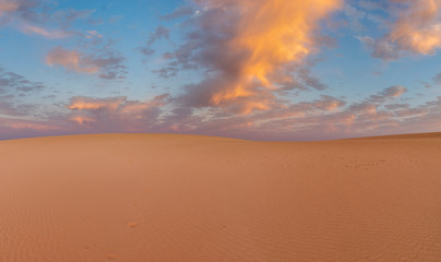 Fototapeta na wymiar Sand dunes in the National Park of Dunas de Corralejo during a beautiful sunset, Canary Islands - Fuerteventura