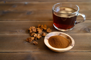 chaga tea mushroom from birch tree using for healing tea or coffee in folk medicine. ground powder