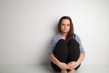 Lonely and sad woman on white background with copy or negative space