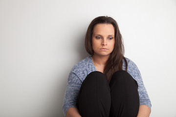 Lonely and sad woman on white background with copy or negative space