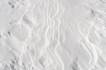 White snow surface texture with soft shadow.