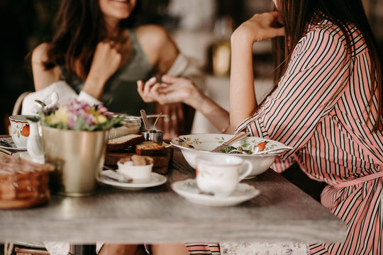Two girls have lunch in a restaurant