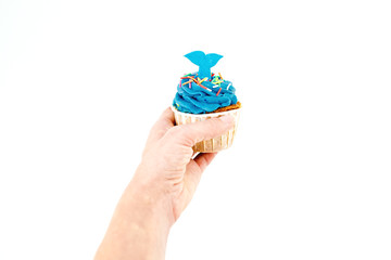 Woman hold blueberry muffins with cream on white background. Flat lay