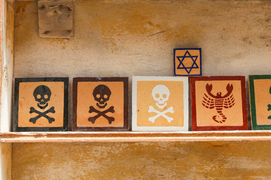 A tablet with a skull and bones, a scorpion and a star of David
