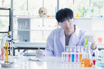 Fototapeta premium Scientist recording experiment result in lab room..