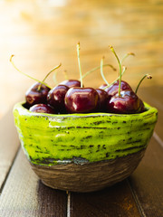 Bowl of cherries on a table