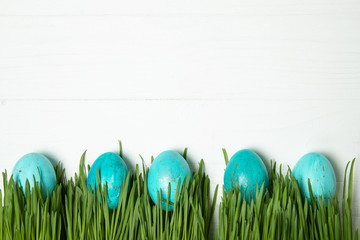 Easter eggs in fresh green grass. On white background