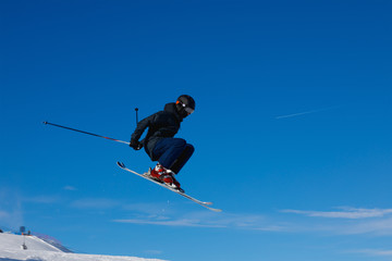 Fototapeta na wymiar Skier jumps in air