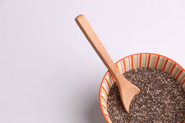 Fototapeta na wymiar Bowl with chia seeds and wooden spoon