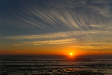 Sunset on the ocean with beautiful clouds