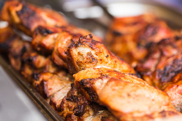 Delicious bbq kebab grilling on open grill, outdoor kitchen. Food festival in city. Tasty food roasting on skewers, food-court. Summer picnic