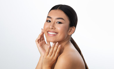 Skincare concept. Asian girl enjoying result of beauty treatment