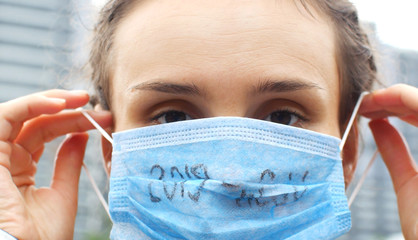 Portrait of a woman in a medical mask protecting against the 2019-nCoV virus epidemic