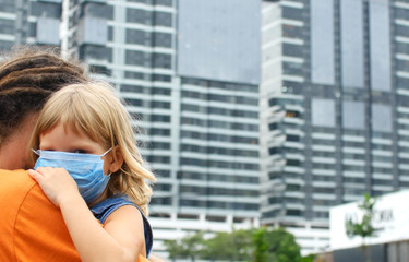 Fototapeta na wymiar Parent hugs the child. Fighting the 2019-nCoV Virus Outbreak