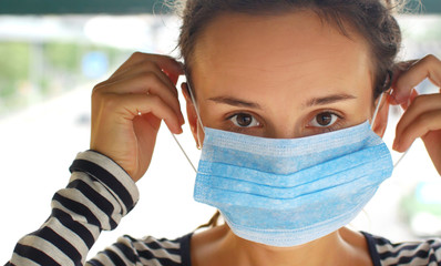 Portrait of a woman in a medical mask protecting against the 2019-nCoV virus epidemic