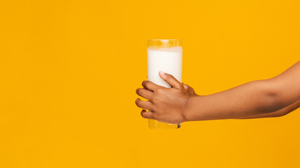 Cropped of black kid holding glass of milk
