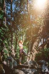 Yoga for greater self control. Full-length shot of caucasian woman standing in Tree pose, Vrksasana while practicing yoga outdoors, in a garden. Healthy lifestyle and relaxation concept
