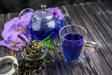 Obraz na płótnie Canvas Cup and teapot butterfly pea flower blue tea. Healthy detox herbal drink.