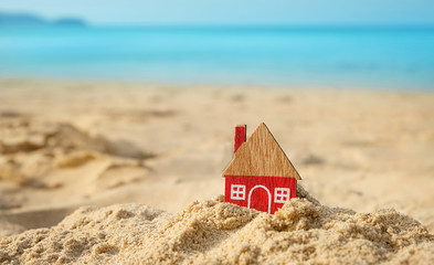 little red house on sand beach, tropical natural background. Home, symbol of love, family. Concept...