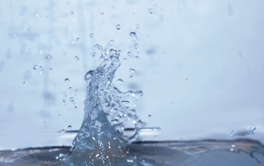 Water splashes against a blue background