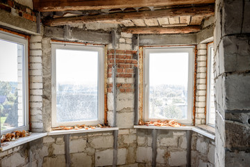 The use of aluminum rails for preparing walls for applying plaster. Installation of guides for plaster. Installation of metal lighthouses on a brick wall.