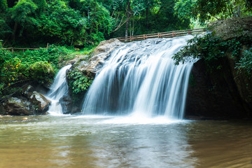 Fototapeta na wymiar Mae Sa waterfall in Chiang Mai, Thailand. Beautiful Maesa waterfall in cool day light with green trees in Chiangmai province, Thai