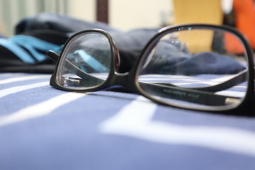 Glasses on the bed.