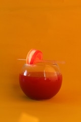 Fresh tomato cocktail with yellow colored backdrop
