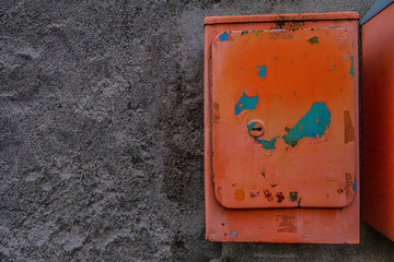 Old orange box hanging on the wall