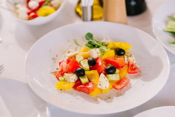 Delicious vegetables in a fresh salad with black olives and pieces of cheese. Healthy, dietary nutrition