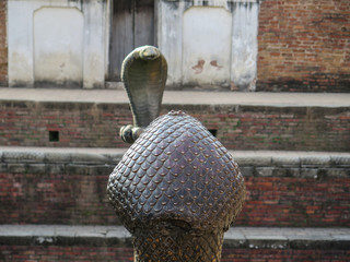 Two snakes facing each other in a monument in Bhaktapur, Nepal