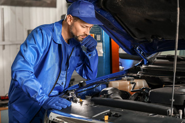 Fototapeta na wymiar Male mechanic working in car service center