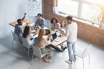 Multiethnic group of employees having business meeting discussion