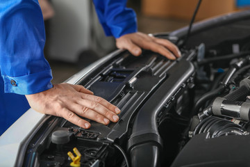 Male mechanic working in car service center