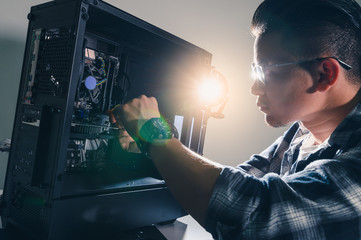 The technician hold the screwdriver for repairing the computer. the concept of computer hardware,...