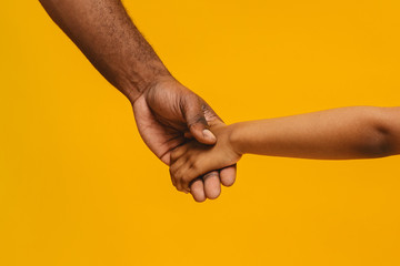 Cropped of african father and daughter holding hands - Powered by Adobe