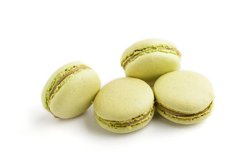 Green macarons or macaroons cakes isolated on white background,  side view.