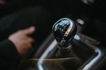 Detail of a manual gear lever in a new modern car. travel concept - obrazy, fototapety, plakaty